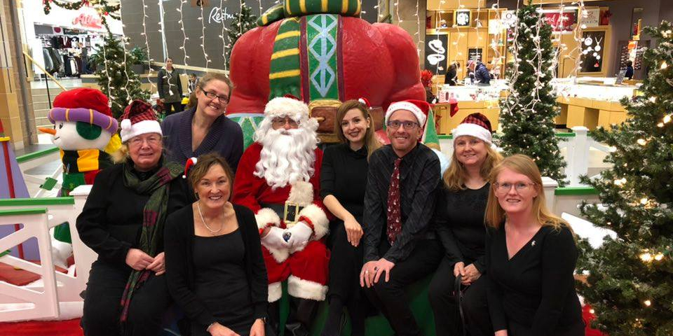 A few choir members at the mall with Santa.
